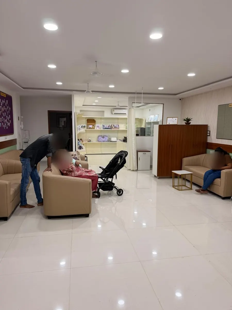 The waiting lounge with beige sofas and the pharmacy counter in the background